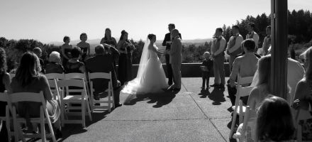 Video thumbnail: a bride and groom in black and white, getting married, surrounded by guests